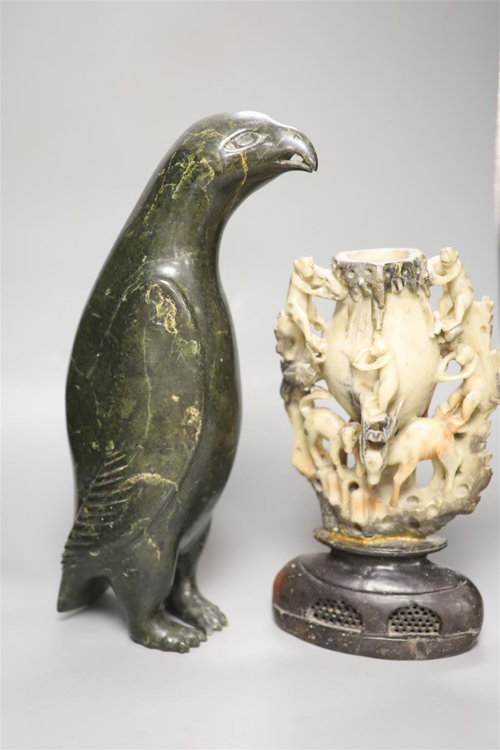 A 19th century Chinese soapstone vase, carved with monkeys, together with an inuit stone carving of a penguin, height 41cm